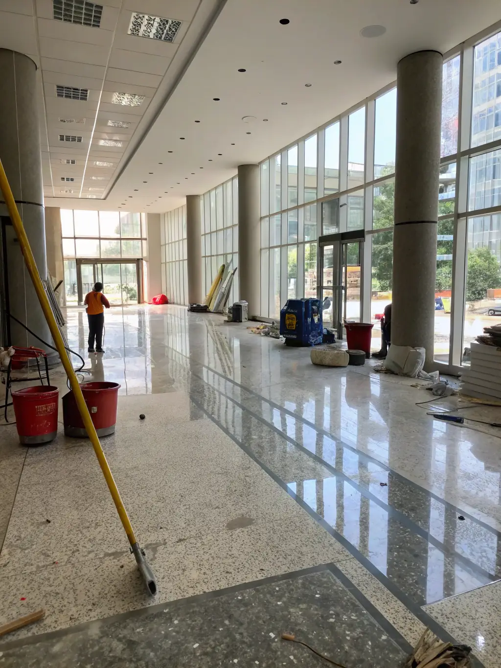 A newly constructed room with visible dust on surfaces and windows, highlighting the importance of a final clean. The image should be bright and showcase the potential of the space after cleaning.
