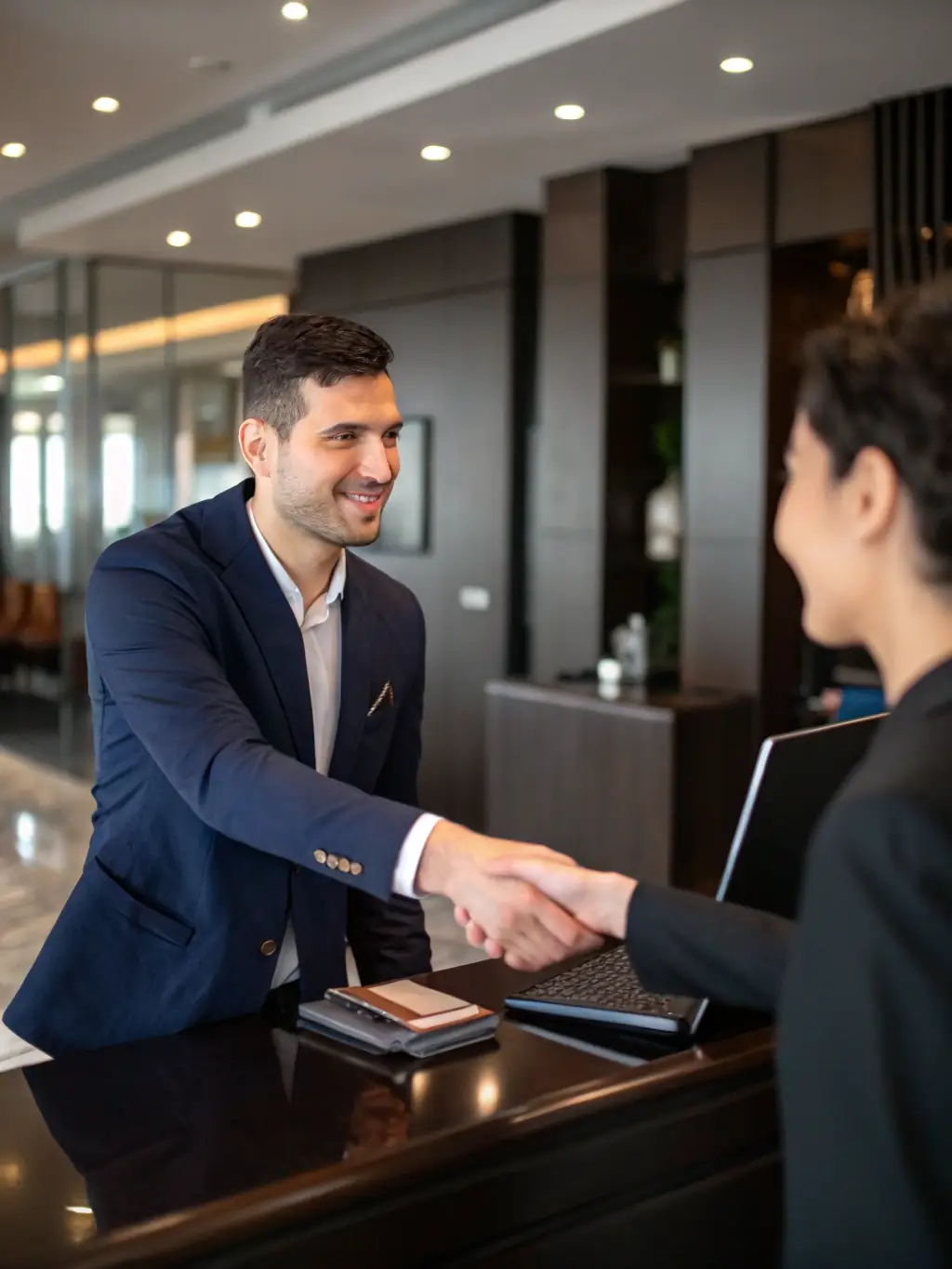 A smiling customer shaking hands with a Premium Peak Cleaning Co. technician, symbolizing trust and satisfaction with the service provided.