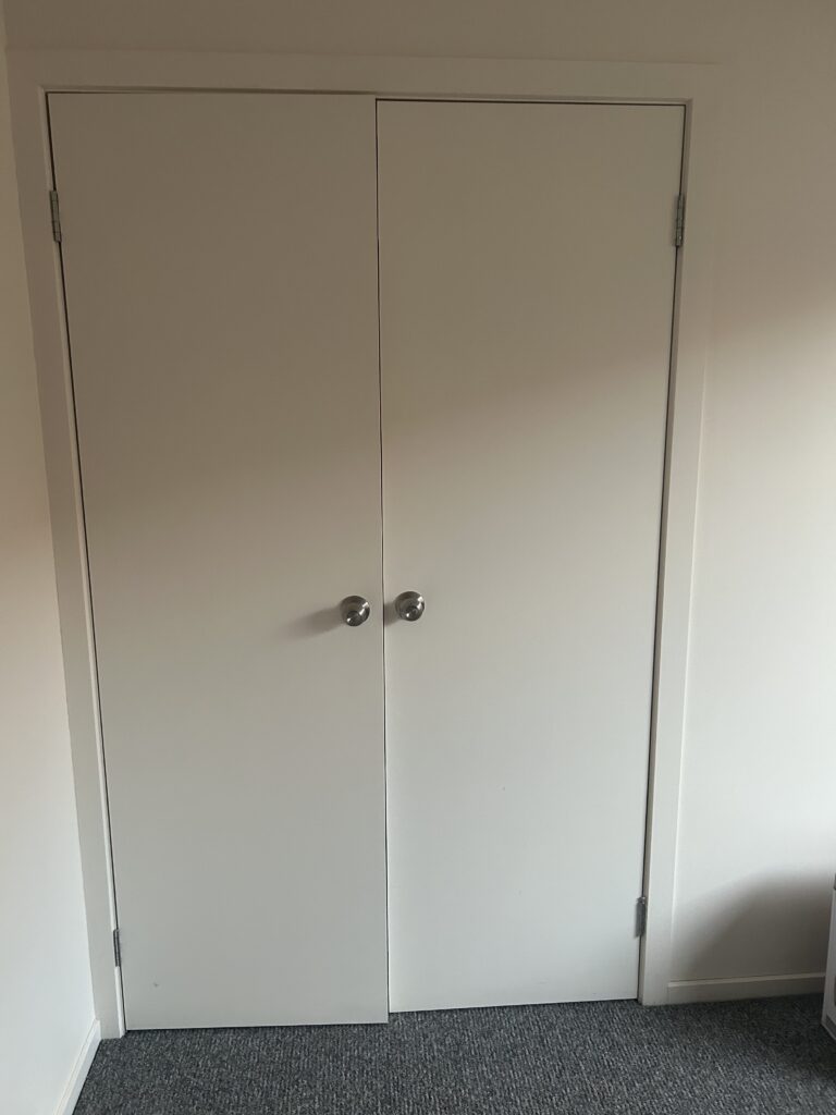 Closed double wardrobe doors after detailed wall and handle cleaning – Wodonga